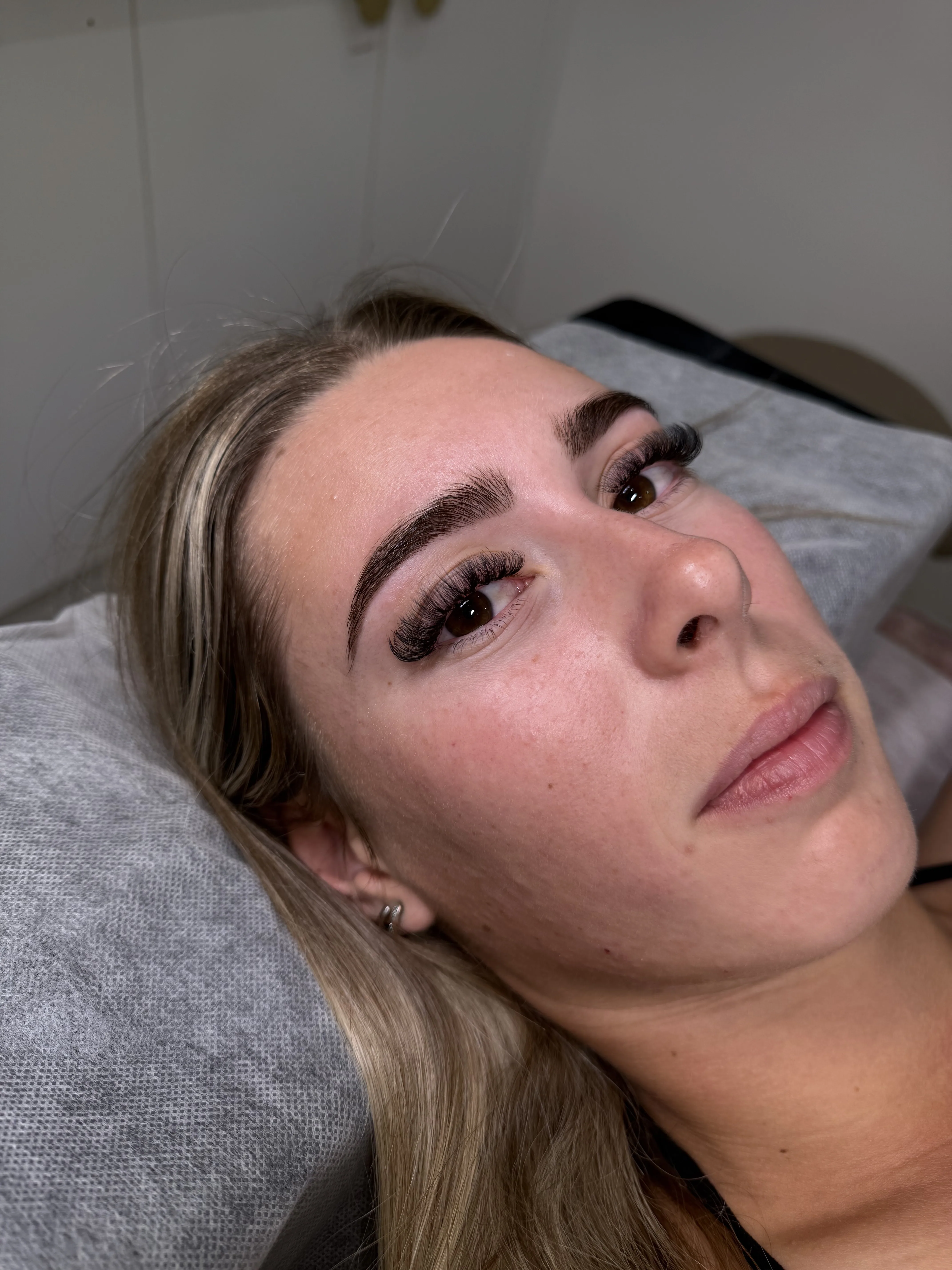 Client with freshly shaped brows in Runway’s beauty treatment room